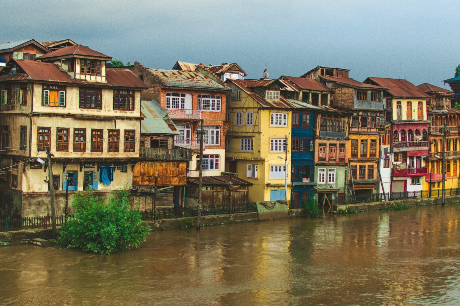 A cluster of old buildings standing along the bank of a river