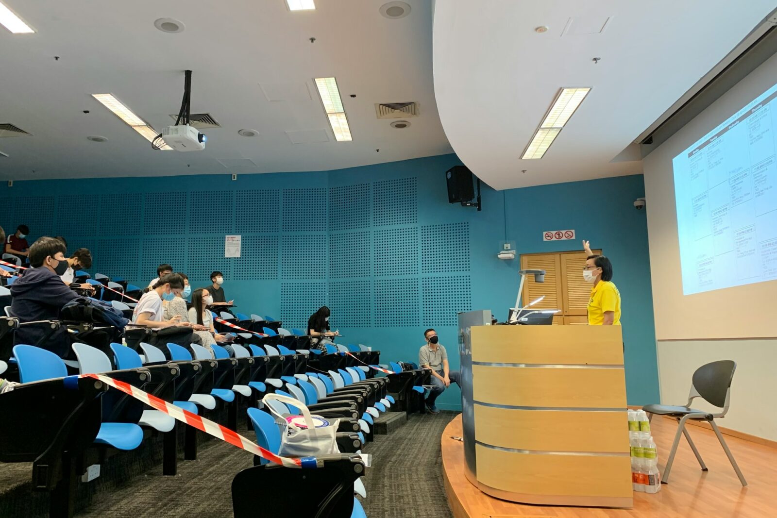 People seated on chairs inside a room