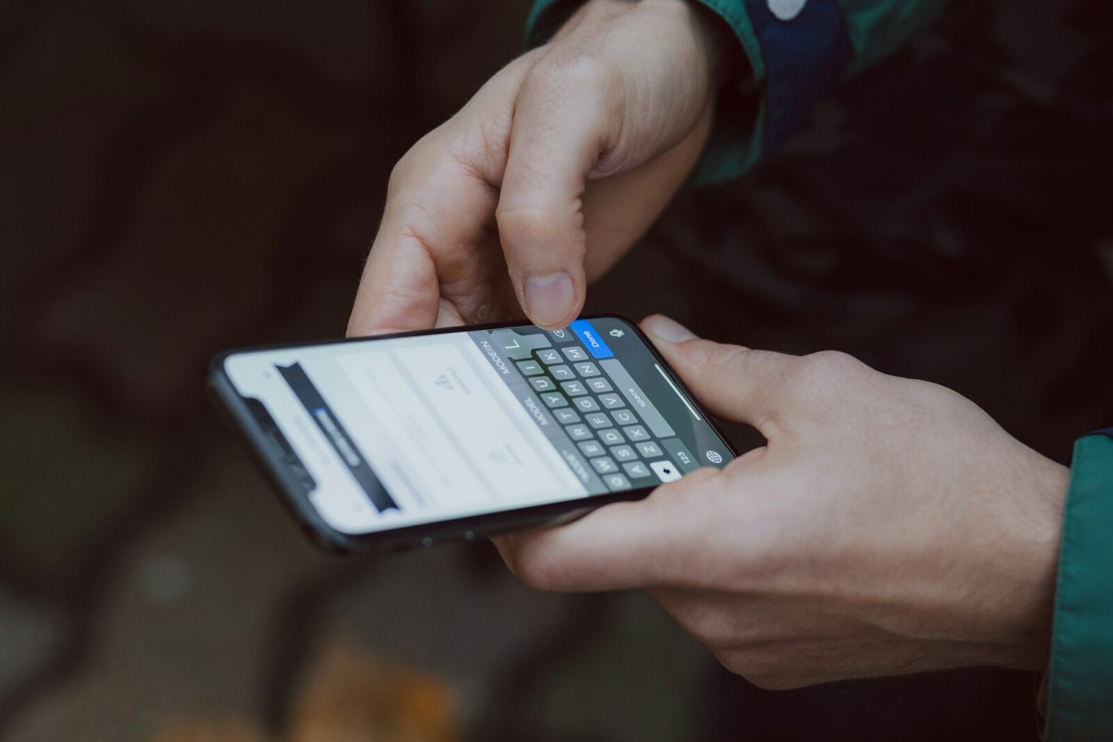 Person using a smartphone, photographed in selective focus