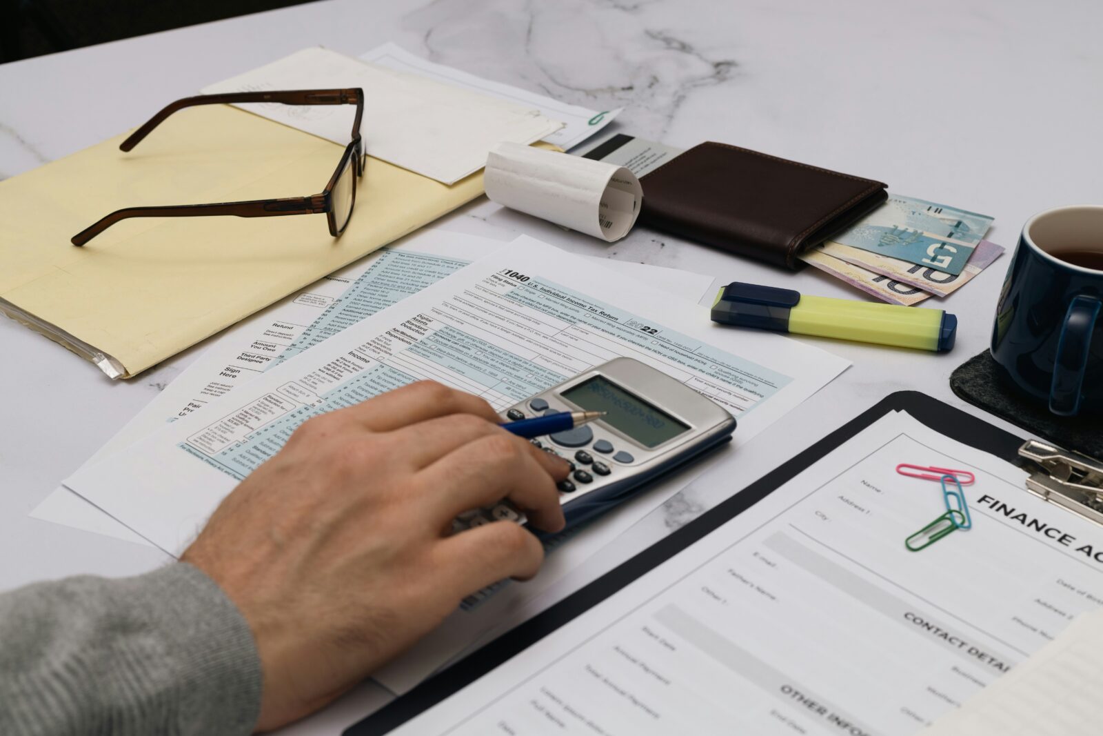 A person working out figures on a calculator at a table