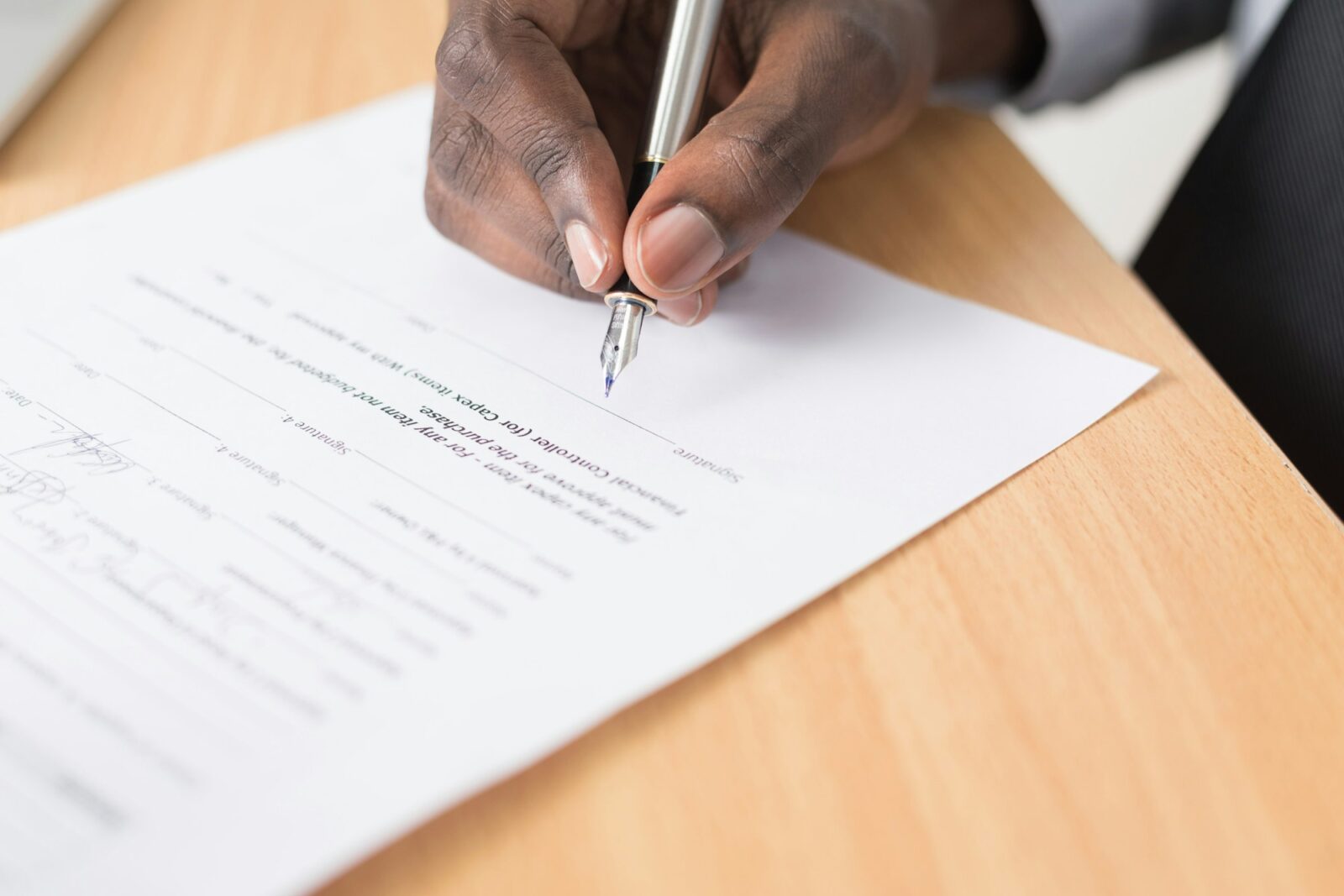 ISB Hyderabad collaborates with ICWA for the development in trade and culture among other areas A person signing a sheet of white paper on a desk