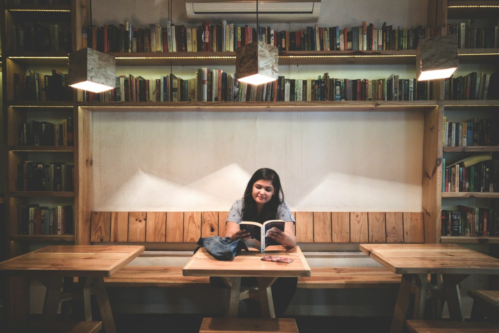 Laadli Scheme witnesses a huge fall in the number of registrations than the preceding year A young woman reading a book between shelves in a library