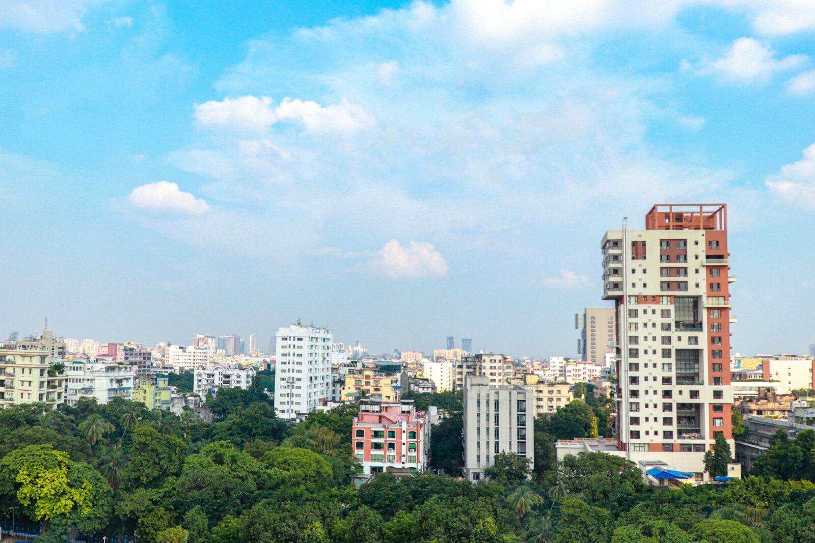 100% placements in IIM Calcutta Kolkata skyline with tall buildings seen from a rooftop under a blue sky