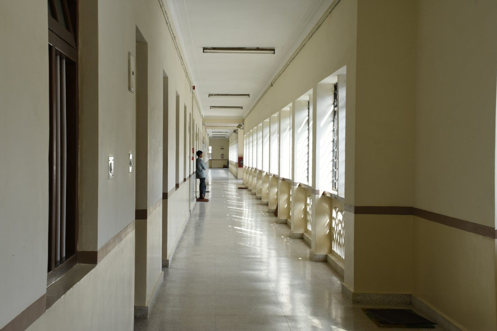 The current academic session will continue till May, says Karnataka Education Minister Person walking down a long, quiet hallway