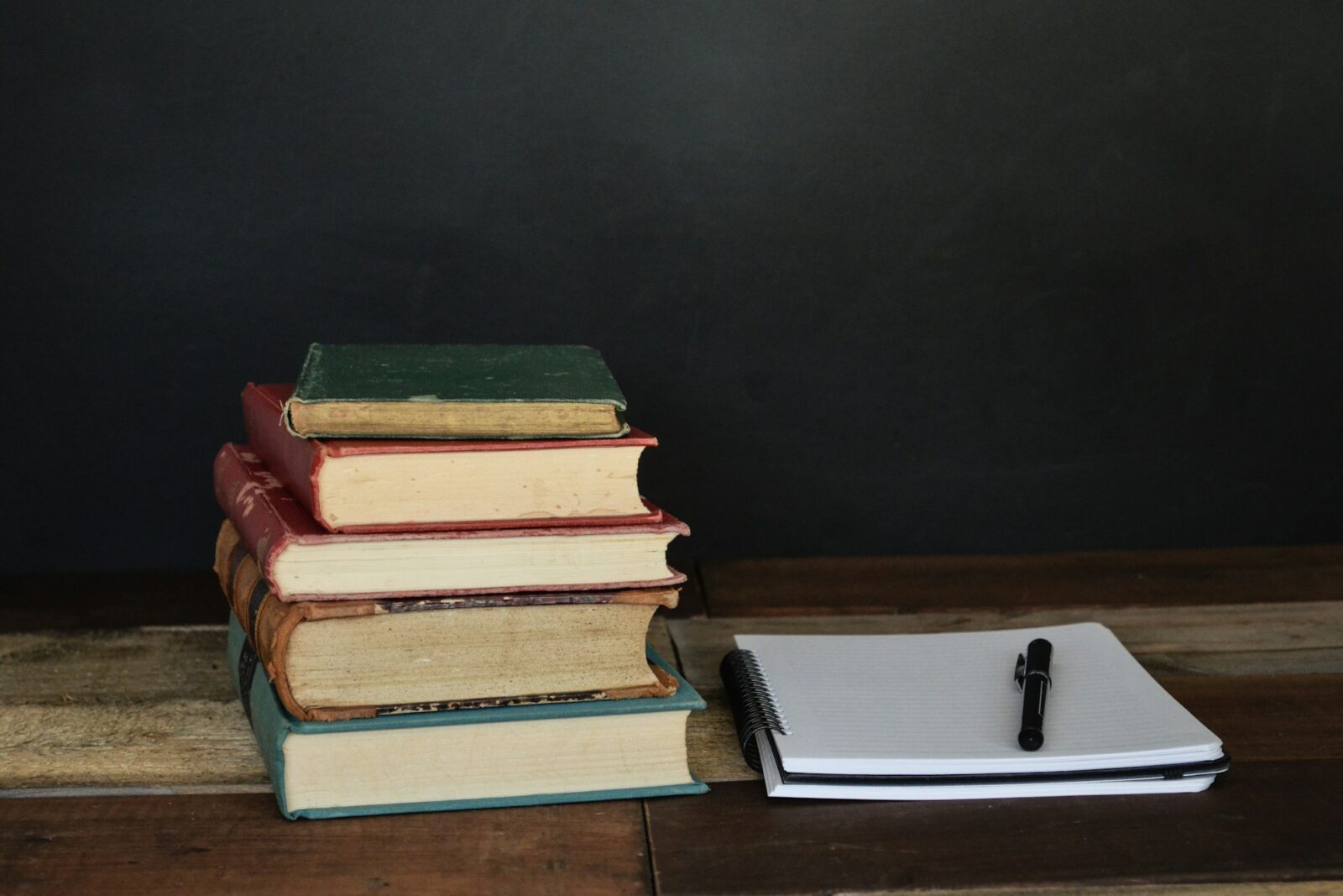 Bihar education department to promote students of classes 1 to 8 without final examination A pile of books beside sheets of white paper and a black ballpoint pen
