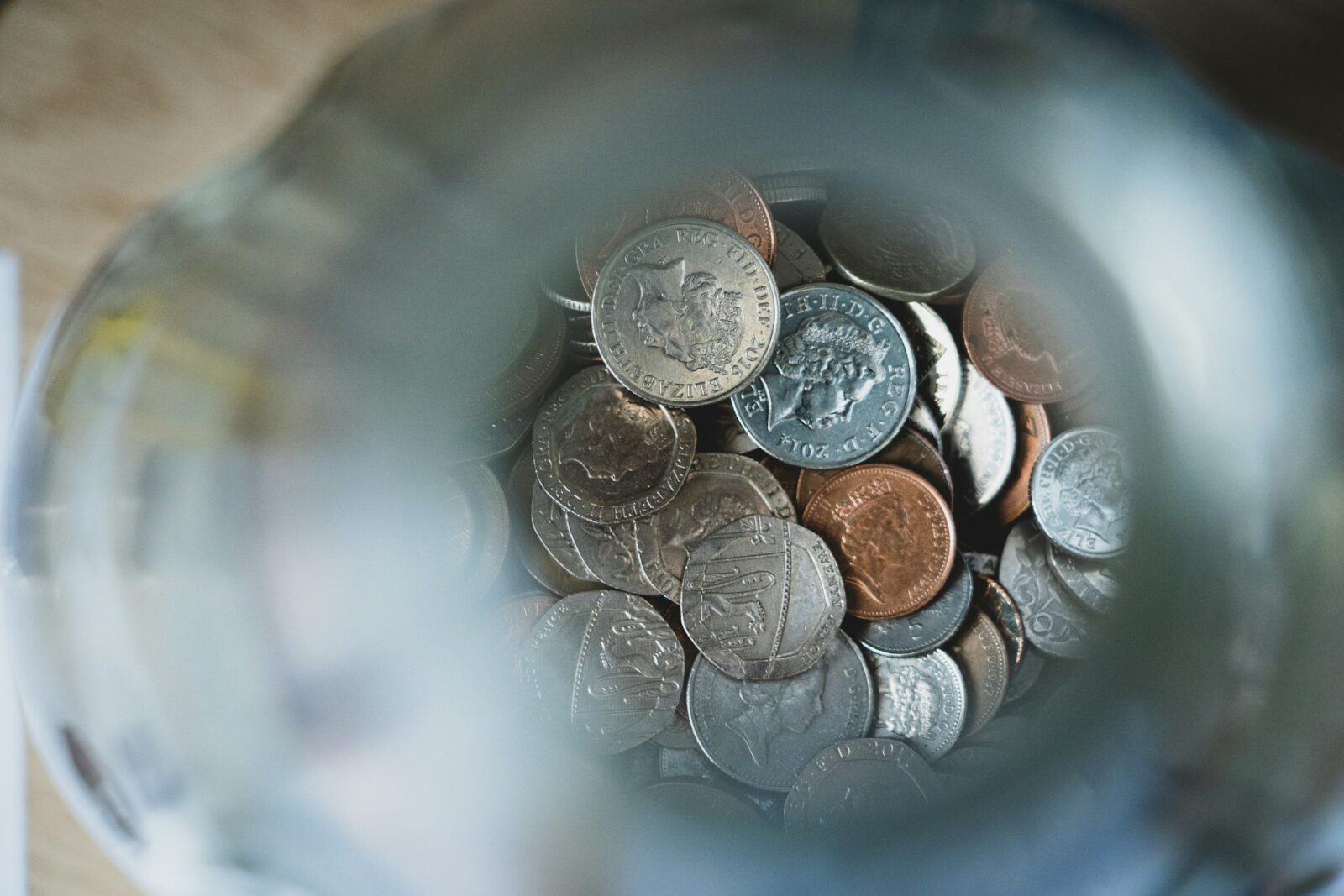Maharashtra: Parents demand action over school fee concerns Looking down into a blue jar filled with loose silver coins
