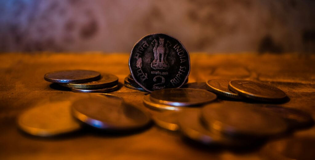 Aakash Educational Services to Be Acquired by the Ed-Tech Giant BYJU'S for $1 Billion Indian rupee coins in close up on a wooden surface