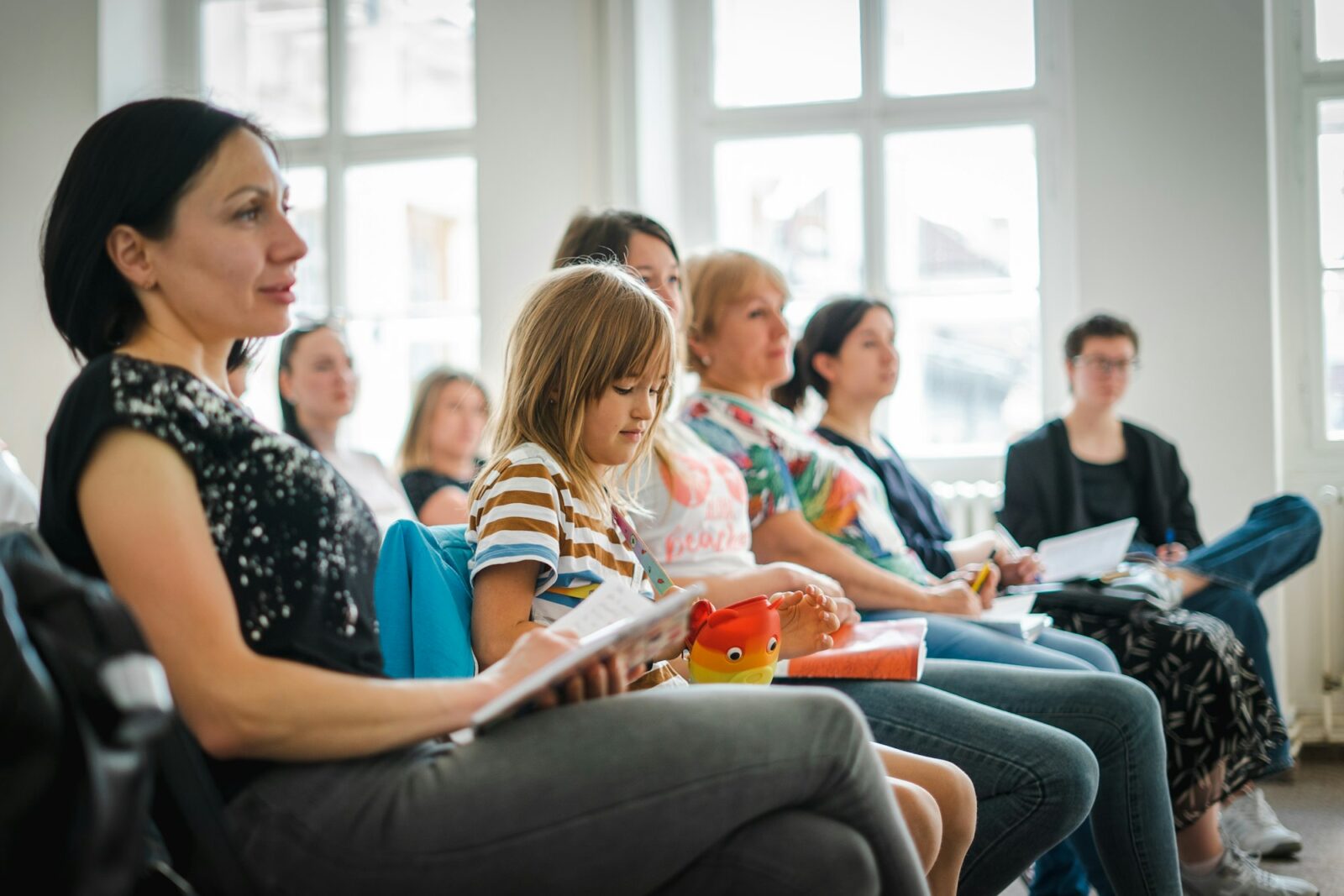 A group of people sitting together in a bright room