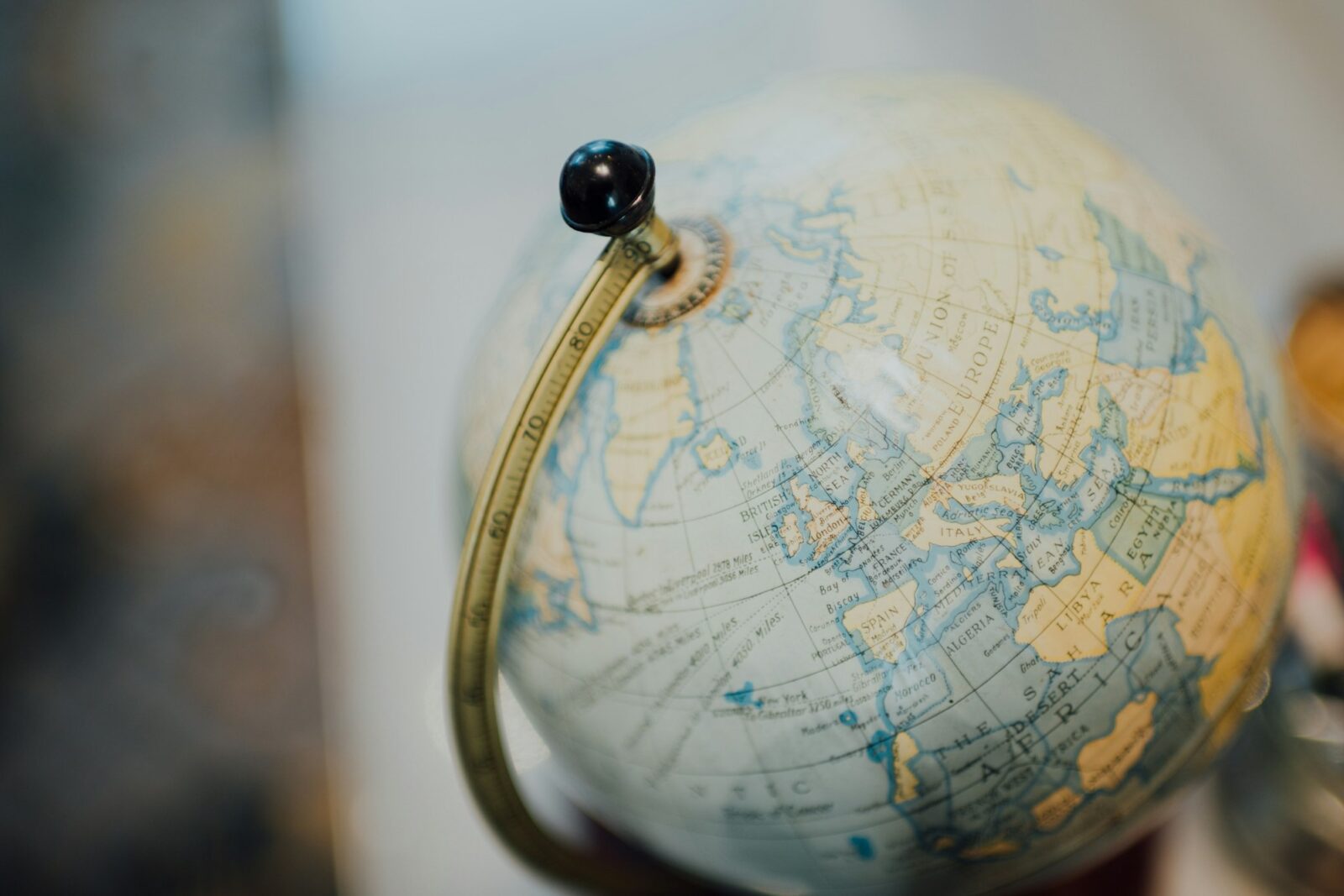Why English Became The Global Language? A gold and silver desk globe