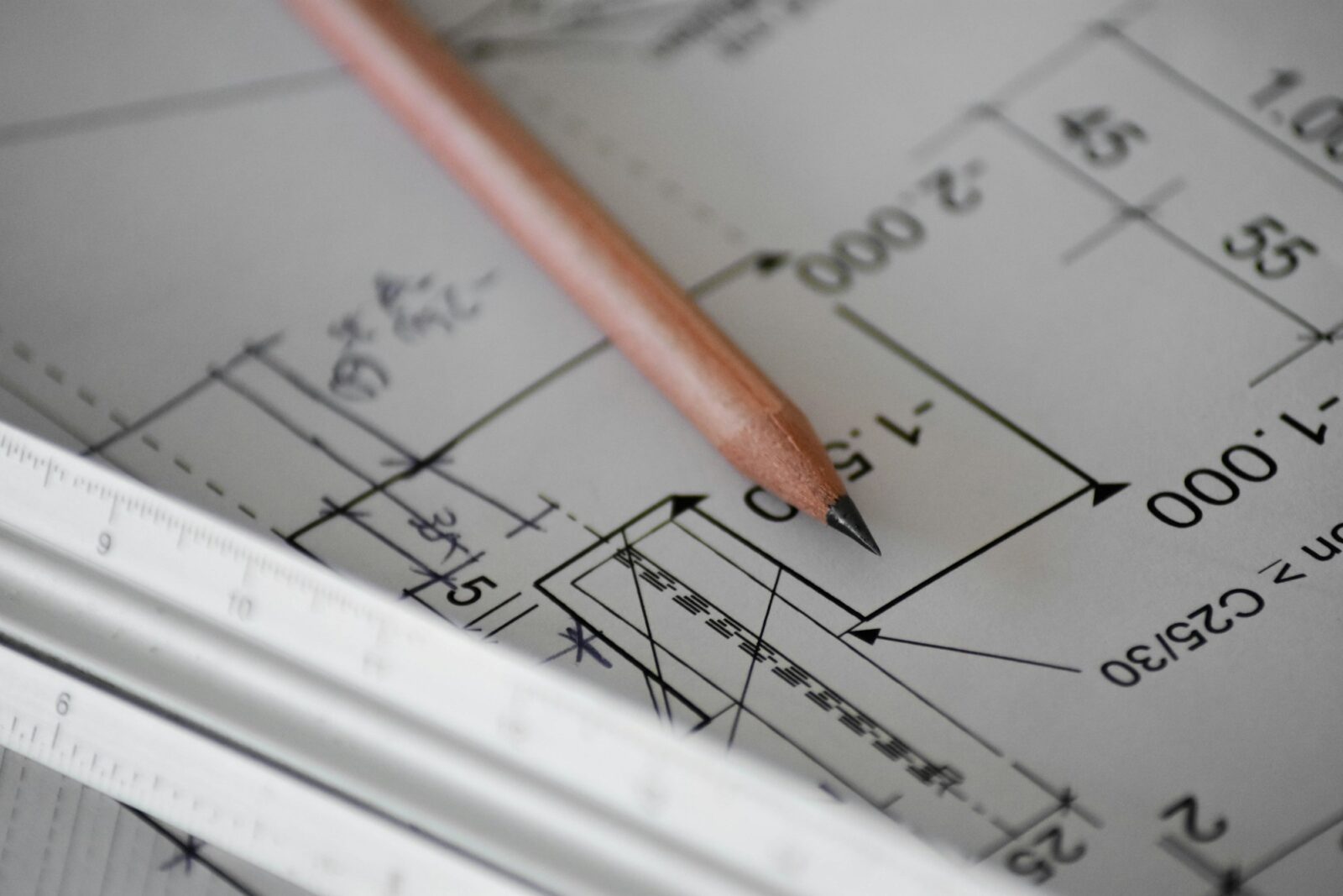 Engineer’s Day; Theme And Significance A pencil resting on sheets of technical drawings and plans