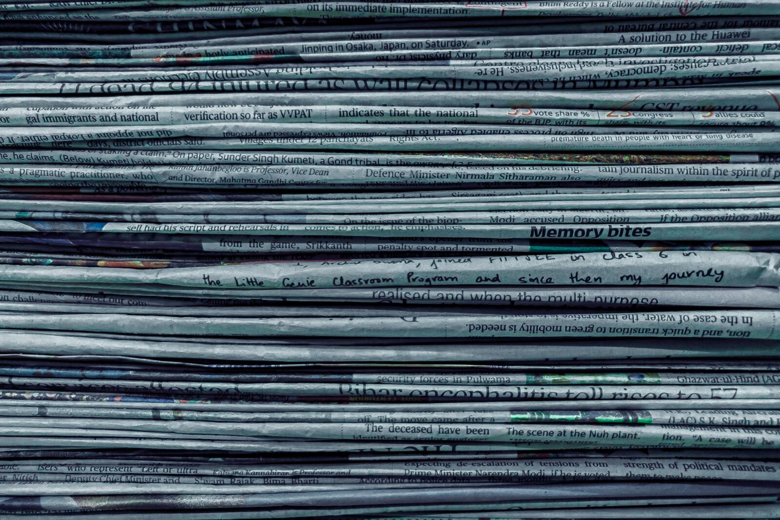 A tall stack of old folded newspapers