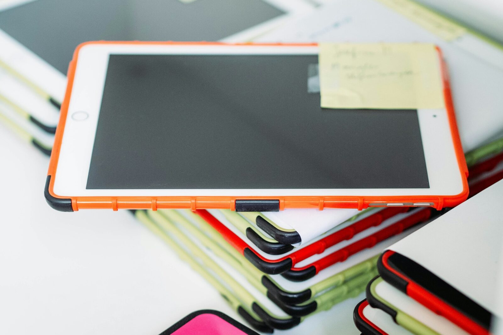 A white tablet computer lying on a white classroom table