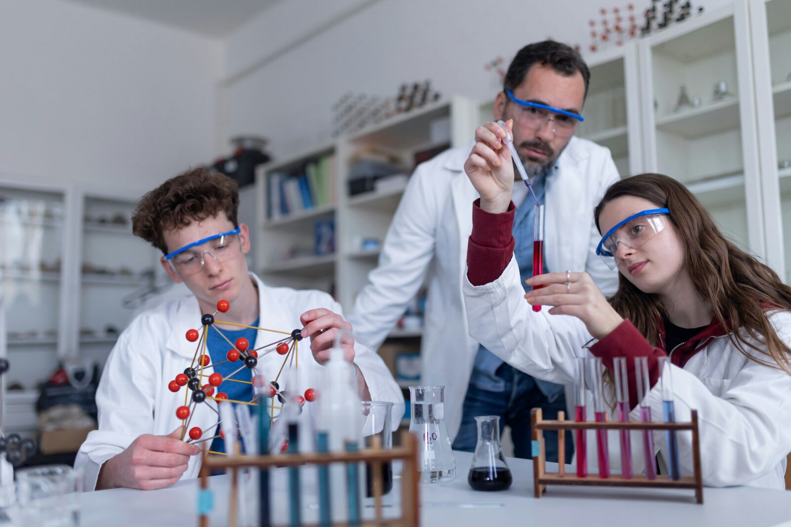 Science students and a teacher carrying out an experiment in a university laboratory