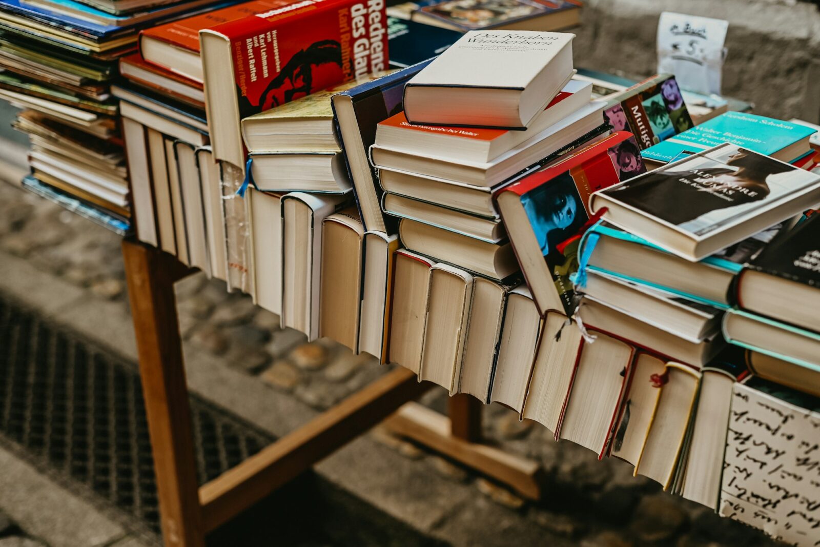 10 Life-Changing Books That Will Transform Your Perspective Pile of books on a wooden table