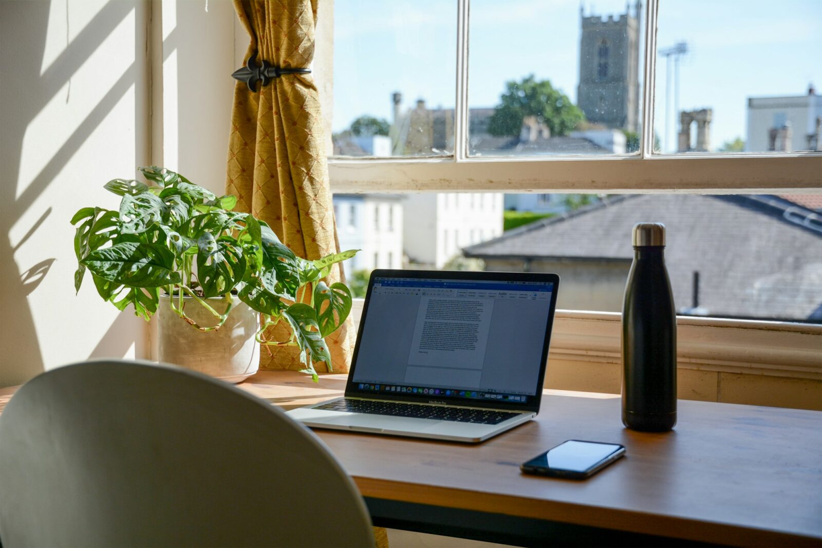 Top 9 Universities Offering Free Online courses Laptop on a brown wooden table set up for working from home