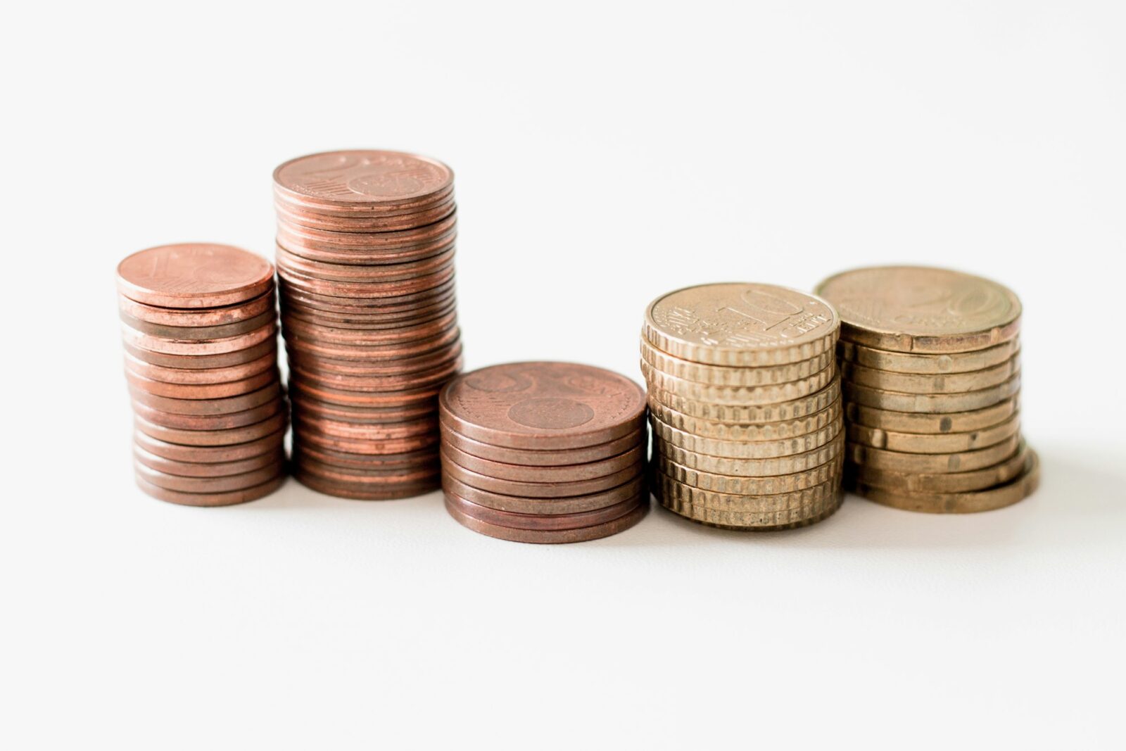 According to a White House analysis, Biden’s proposal to eliminate some student loan debt would cost $379 billion Stacks of gold coloured coins of rising height on a white surface