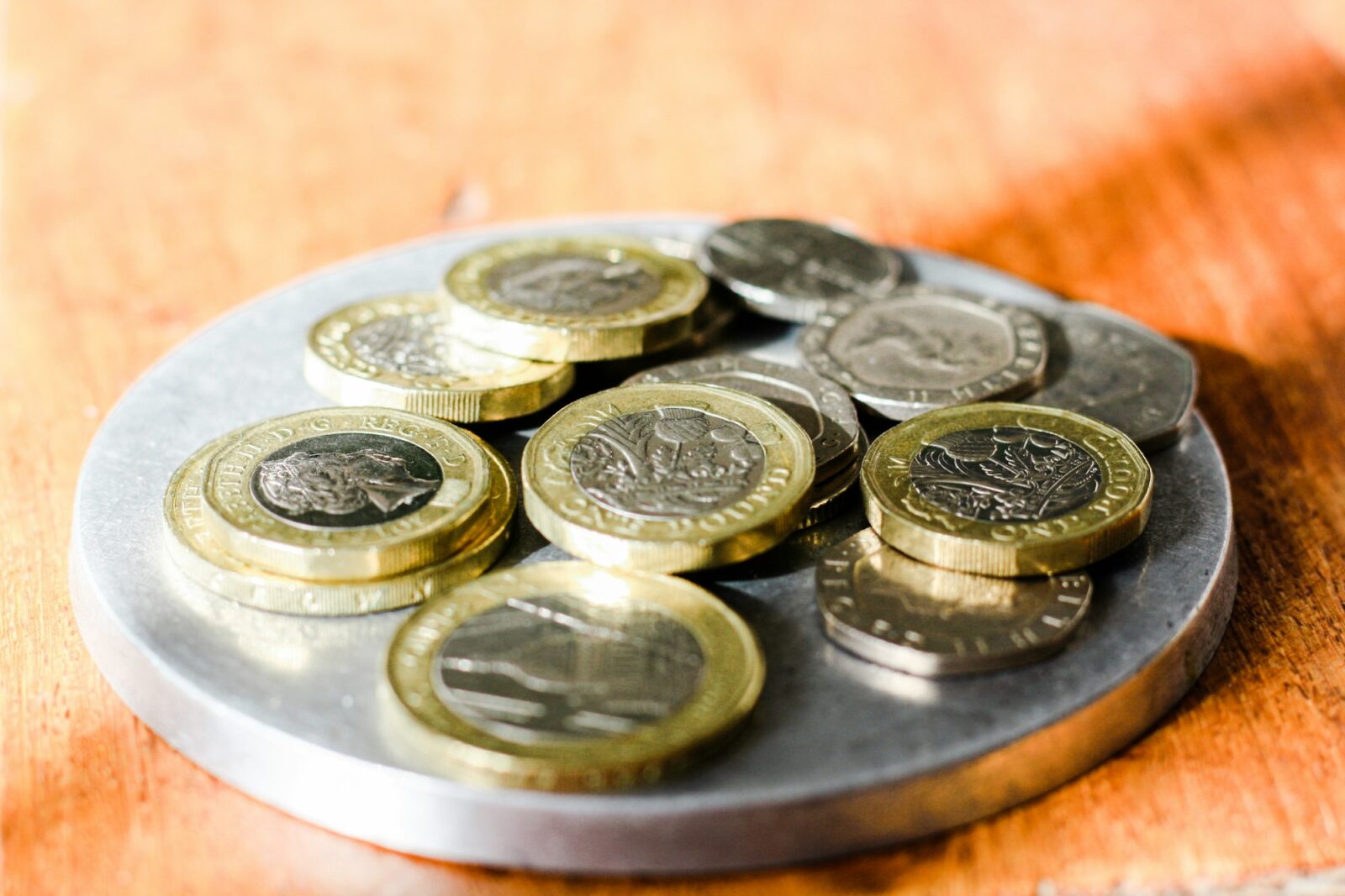 “Bad value for money” for university tuition in England and Wales the survey Loose British coins including one pound, two pound and twenty pence pieces