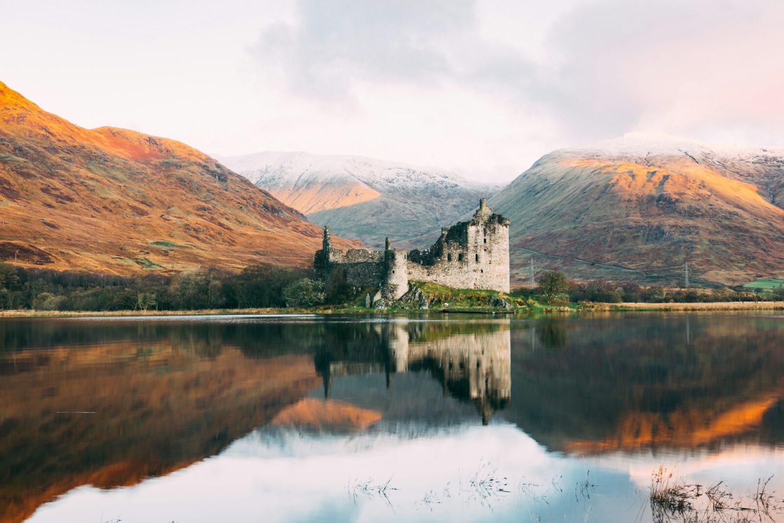 Kilchurn Castle ruins reflected in the calm water of Loch Awe, Scotland