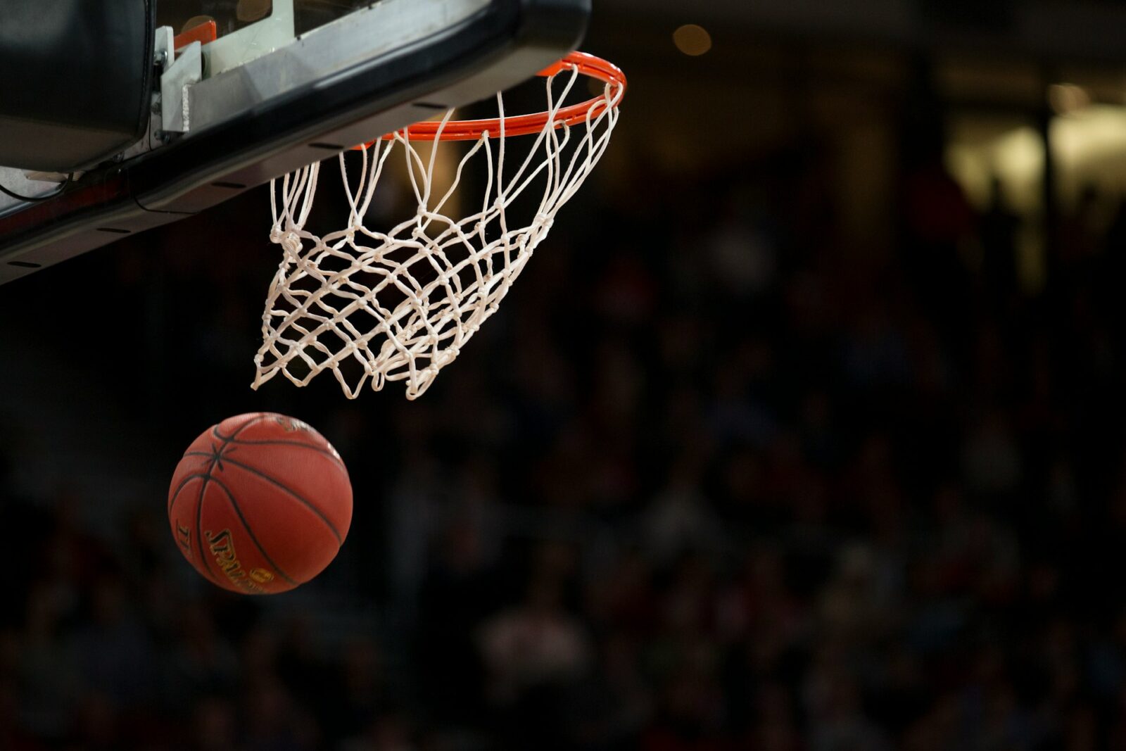 New $2 million school sport and physical activity grant program announced by PHE Canada Basketball resting on an indoor court beneath a basketball hoop