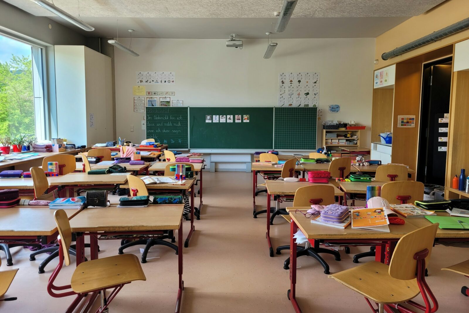 Empty school classroom filled with rows of desks and chairs