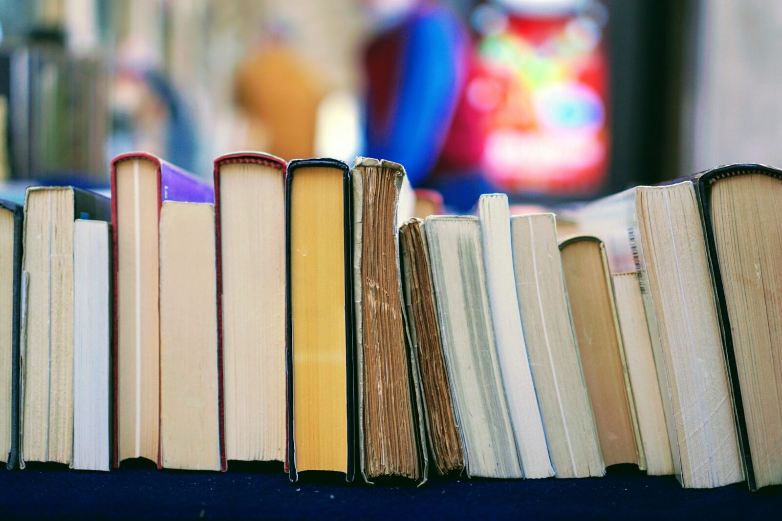 Piles of second hand books laid out on a table at a book market