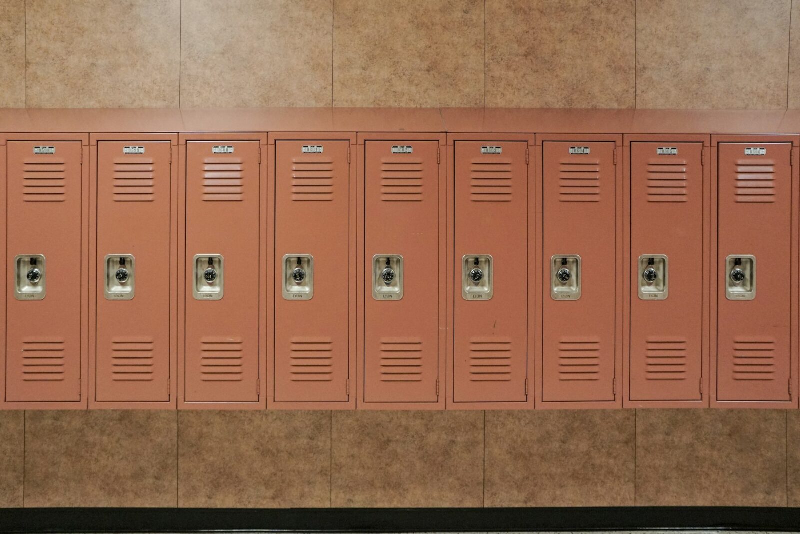 NYC middle schools reinstate selective admissions, however on a far smaller number of campuses Row of red metal school lockers above green tiles along a school corridor