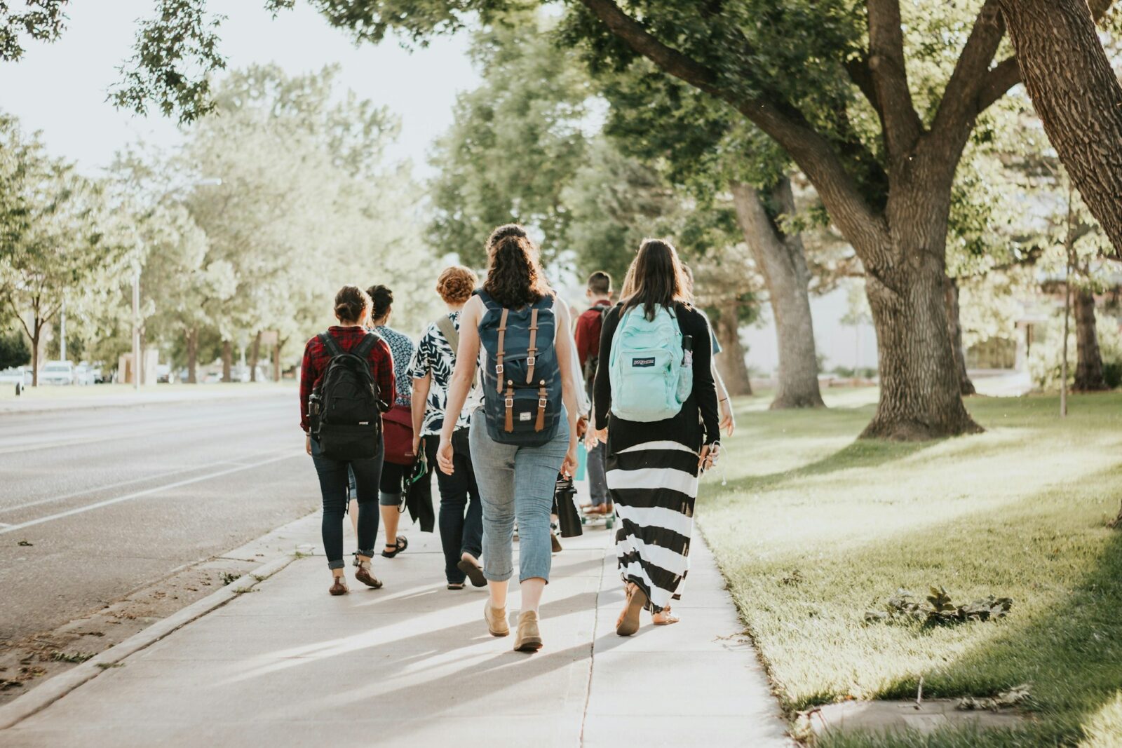 Group of people walking together along a road