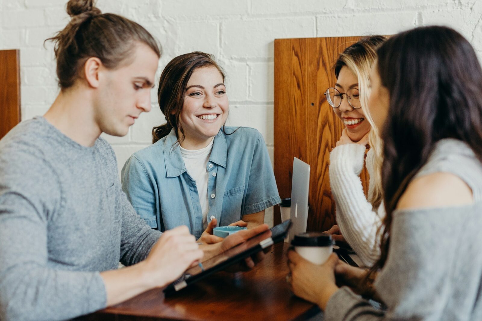 Group of friends chatting around a table in a coffee shop