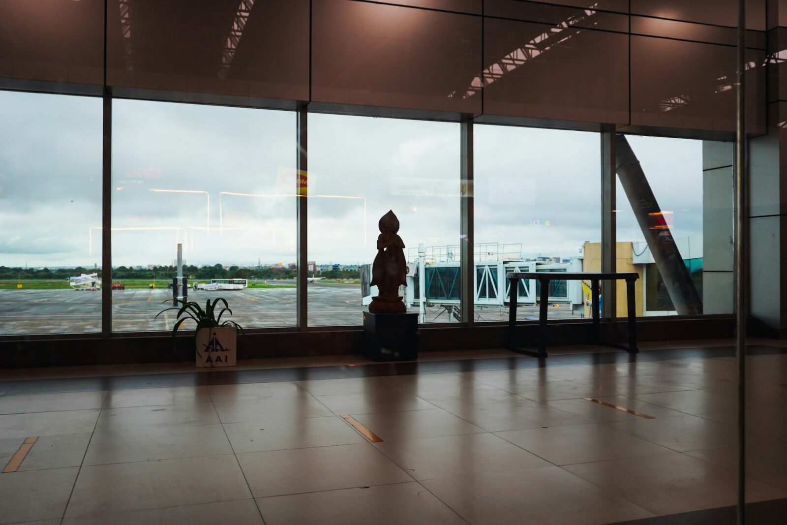 Airport lounge with large windows looking out over the tarmac and parked aircraft