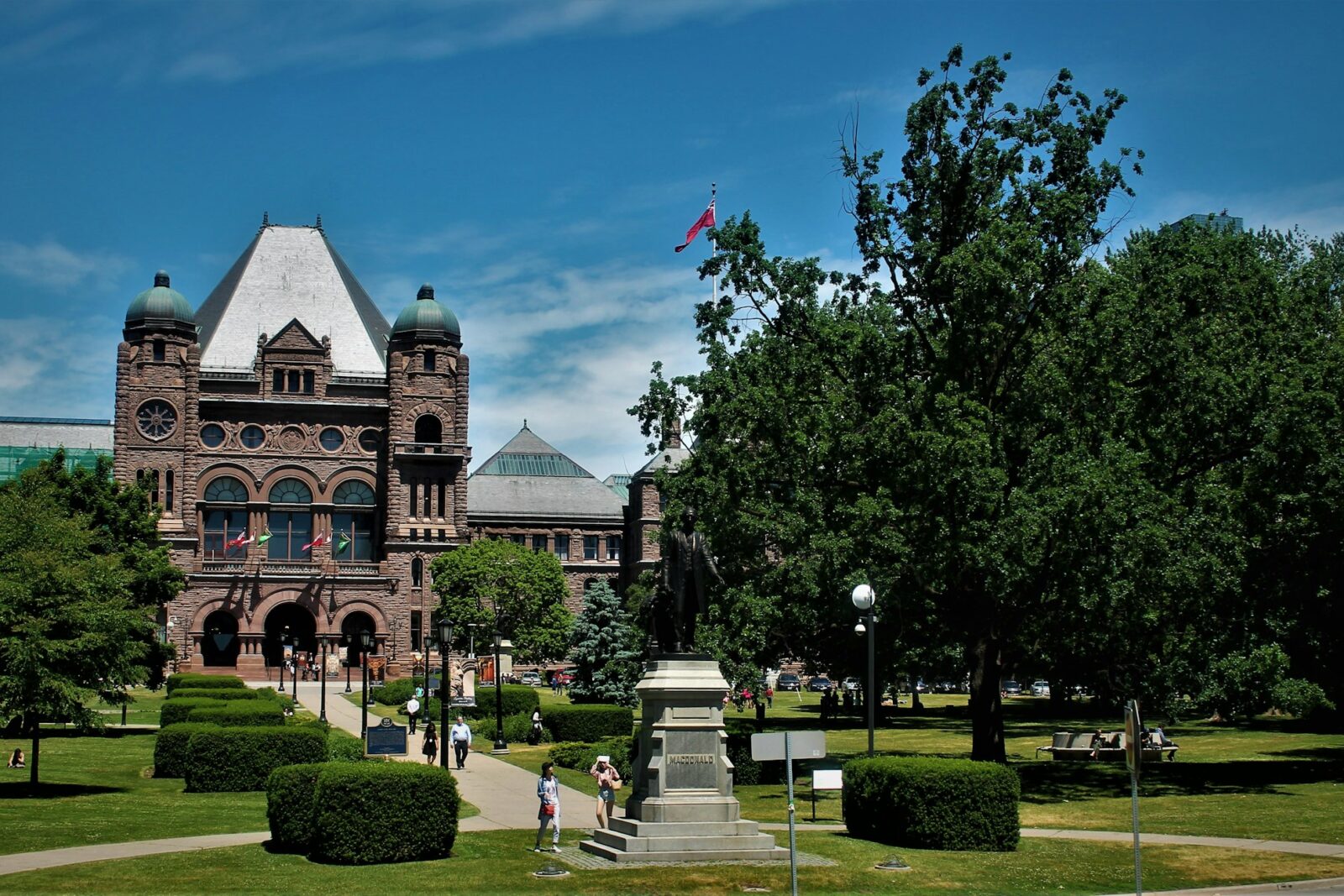 Brown stone building on a university campus in Toronto under a blue sky