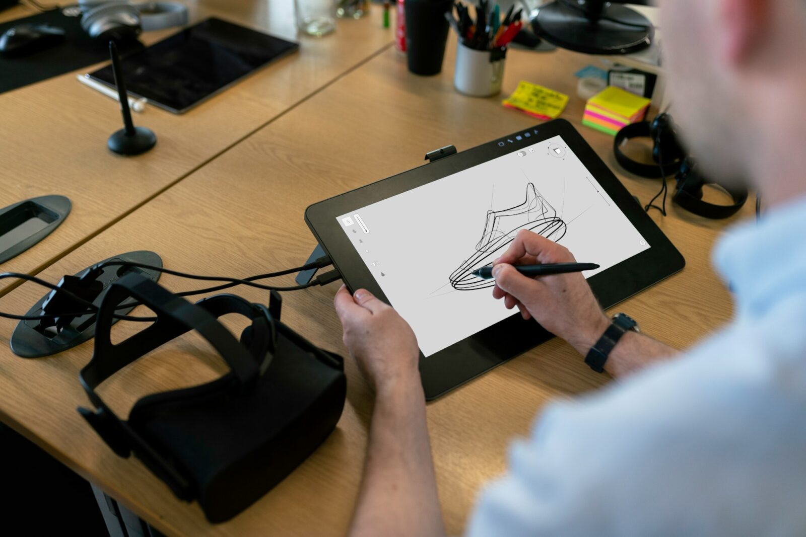 The use of VR and AR in education Design engineer sketching on a tablet with a stylus while testing virtual reality software