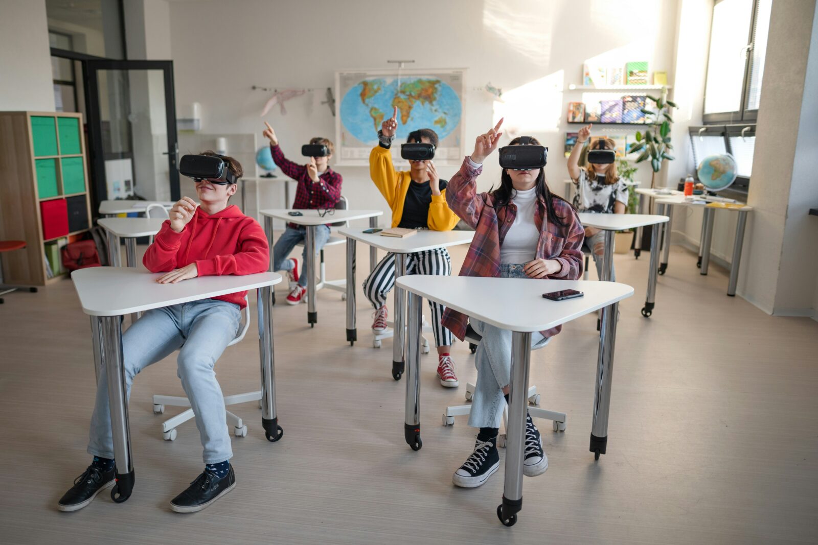 The Impact of Virtual Reality on Education: Enhancing Learning through Immersive Experience Students wearing virtual reality headsets while seated at classroom desks