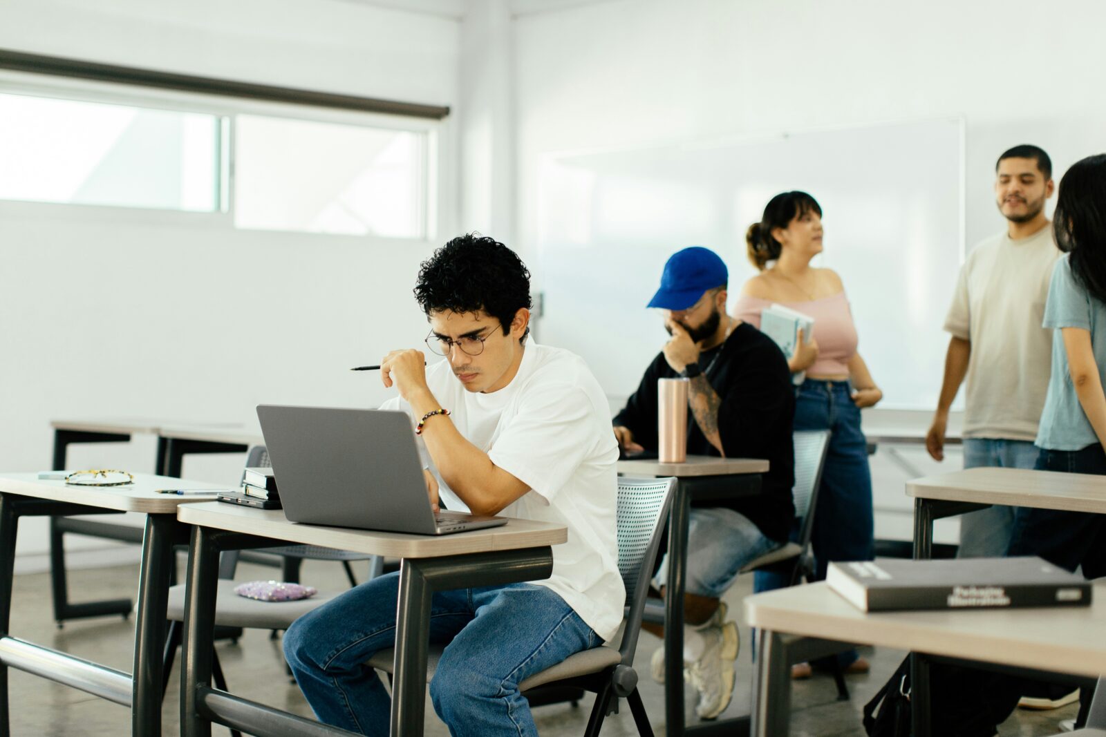 Students sitting at desks and studying together in a classroom