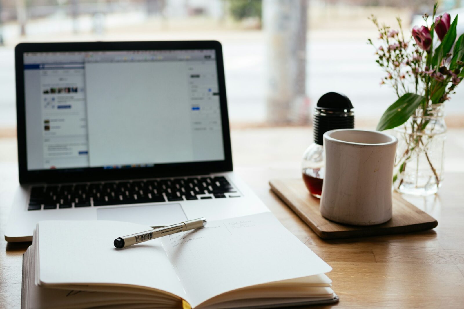 Best E-Learning Platforms: Comparison and Analysis Laptop beside an open notebook on a desk