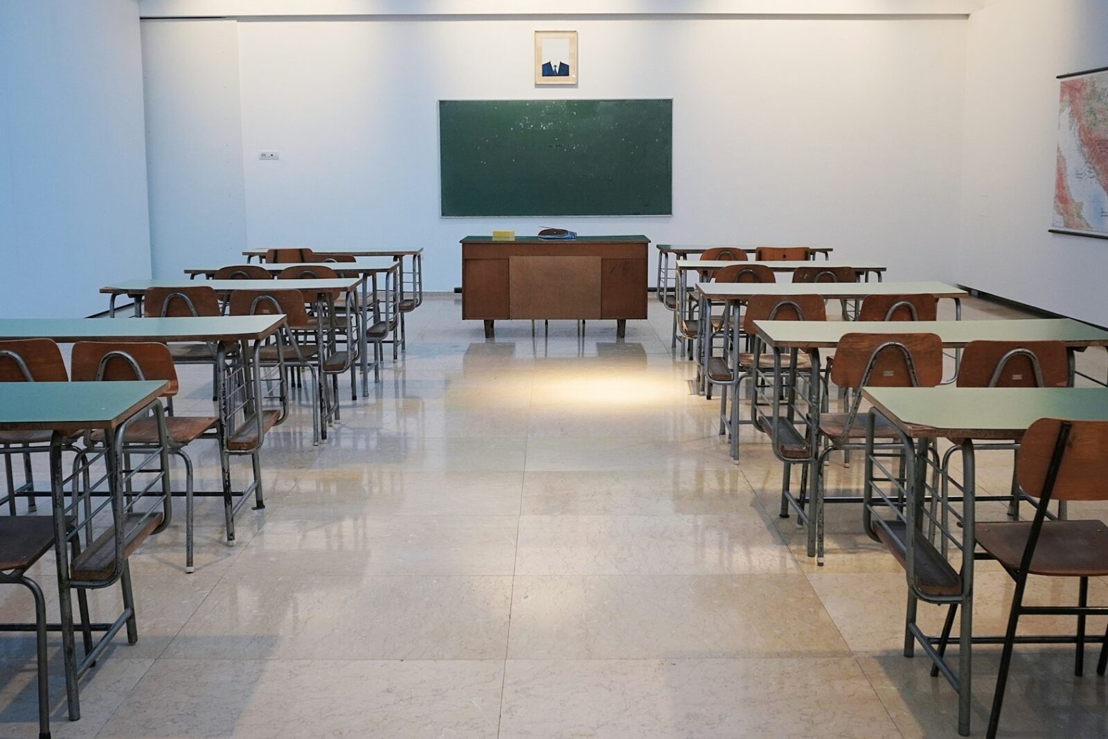Outrage among parents in the UK over proposal to prolong school break Empty classroom with rows of desks facing a chalkboard